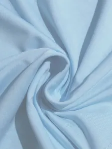 Macro close-up of light blue ribbed fabric showing soft texture and fine knit knit detail.