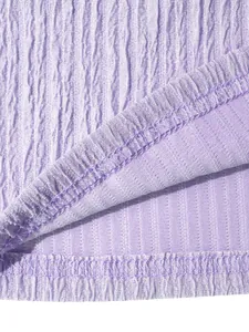 Macro view of purple textured pleated fabric showing neat stitching and fine detail