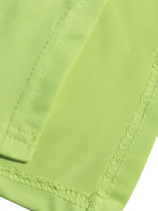 Close-up of fluorescent green fabric showing high-quality stitching and seams.