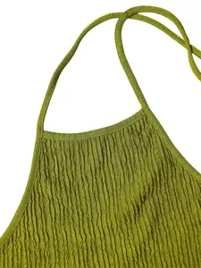 Close-up view of the olive green pleated textured fabric on a halter neck crop top detail