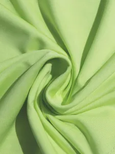 Detailed macro shot of lime green ribbed knit fabric texture for sexy summer dress
