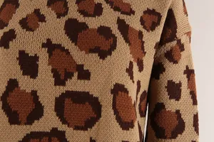 Macro view of the soft knitted texture and leopard print on a women's pullover sweater.