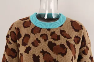 Close-up of leopard print knitted sweater with teal ribbed crew neck