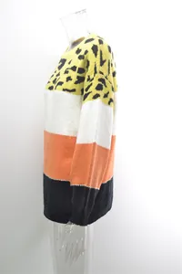 Side view detail of a vibrant color-block knit sweater featuring a leopard print top