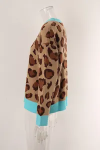 Detailed side view of a women's leopard print knit sweater with blue ribbed trim