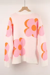 Detailed view of the large flower print and ribbed texture on the pink knit sweater