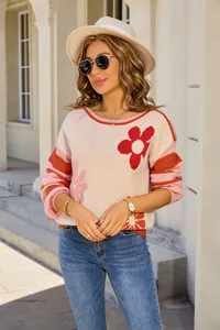 Close-up of women's round neck knit sweater with floral patterns and striped sleeves