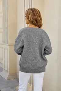 Detailed back view of a grey oversized knit cardigan sweater for women in casual winter style.