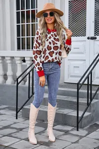 Detailed view of stylish women's leopard print pullover sweater with red ribbed trim cuffs