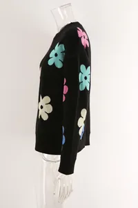 Side view of a black round-neck knit sweater featuring vibrant colorful flower patterns.