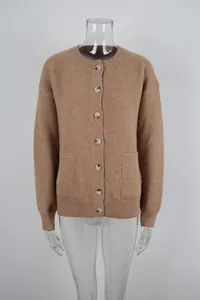 Close-up front view of a camel knitted cardigan sweater with round neck and pockets.