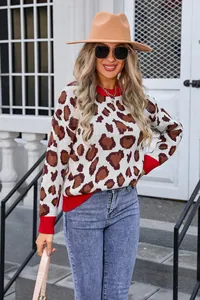 Women's leopard print knit sweater with vibrant red ribbed cuffs and collar.