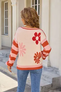 Detailed back view of women's knit sweater featuring floral patterns and striped sleeves