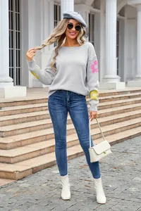 Stylish women's grey boat neck sweater featuring vibrant flower patterns on sleeves