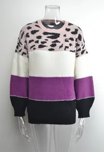 Detail of women's crew neck sweater featuring pink leopard print and color block stripes.