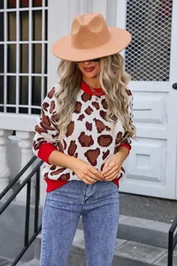 Stylish women's leopard print knit sweater with vibrant red ribbed collar and cuffs