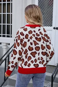 Back view of a plus-size leopard print knit sweater with red ribbed trim details.