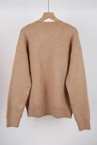 Detailed back view of a classic camel knitted pullover sweater hanging on a wooden hanger