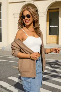 Stylish brown knit cardigan for women styled with a white camisole top in urban setting