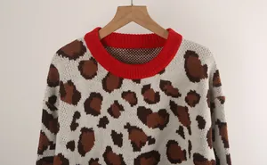 Women's leopard print knit sweater with red ribbed crew neck and long sleeves.