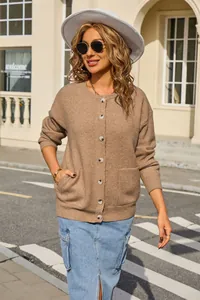 Close-up of a cozy brown knit cardigan with a round neck and front button closure.