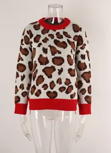 Close-up of knit texture on leopard print sweater with red ribbed cuffs and hem.