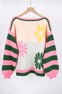Close-up detail of a women's colorful knitted sweater with floral and stripe design