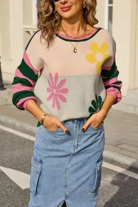 Detail view of women's fashion knit sweater with flower patterns and striped sleeves