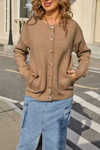 Detail view of a cozy women's brown round neck knit cardigan sweater with pockets