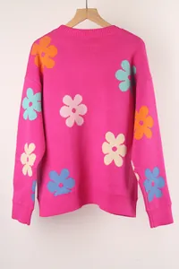 Detail shot of a vibrant pink crew neck knit sweater with colorful jacquard flower motifs