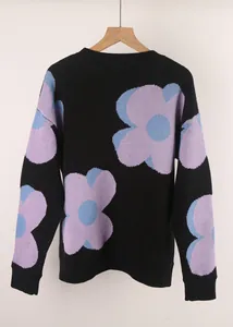Detailed back view of a black knitted sweater showcasing the vibrant purple floral pattern
