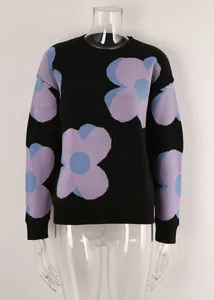 Close-up of black knit sweater with large purple and blue flower print patterns.