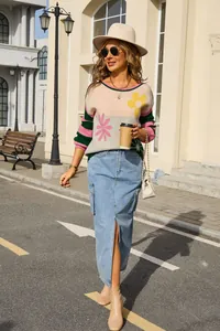 Street style detail of a chic floral striped sweater and denim maxi skirt outfit