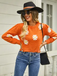 Detail shot of orange knit sweater with white daisy floral patterns and puff sleeves for women