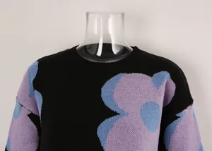 Close-up detail of women's round neck knit sweater with blue and purple floral pattern design
