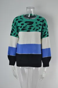 Close-up of women's color-blocked sweater with green leopard print and striped patterns