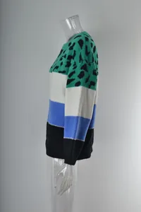 Side view of a color-blocked leopard print knit sweater on a clear mannequin.