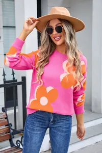 Detail view of women's round neck sweater with vibrant pink and orange floral print