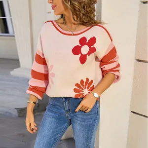 Cozy oversized women's knit sweater featuring red floral print and striped long sleeves