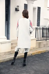 Back view of long knit cardigan featuring geometric sleeve patterns and fringe hem