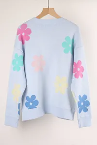 Light blue oversized crew neck knit sweater with colorful floral patterns on the back