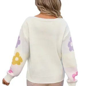 Loose boat neck knitted white sweater with colorful flower patterns on sleeves, back view