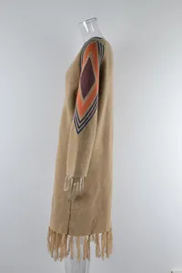 Detailed side view of long knit cardigan featuring fringe and geometric sleeve patterns