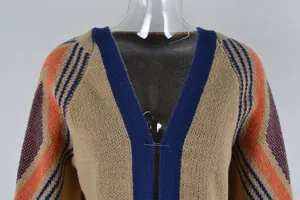 Close-up of a women's knit cardigan with V-neck, orange and blue geometric pattern