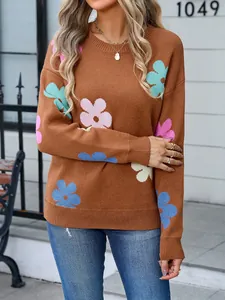 Detailed close-up showing the vibrant floral knit pattern on a brown round neck sweater.