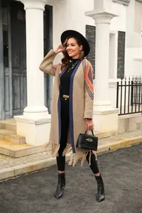 Bohemian long fringe knit cardigan with geometric patterns, perfect for chic spring outerwear.