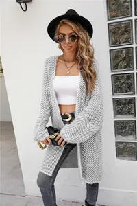 Detail view of a stylish grey herringbone knit long cardigan for women on a model