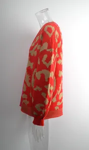 Detaillierte Seitenansicht einer roten Strickjacke mit Leopardenmuster und Rippbündchen