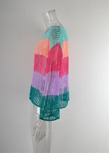 Close-up detail of a colorful striped hollow-out crochet cover-up for summer beach resort.
