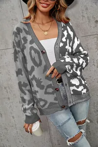 Detailaufnahme eines grauen Oversize-Strick-Cardigans mit Leopardenmuster und Knöpfen am Model